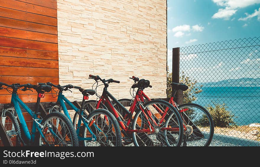 Eco-transport concept. Rental Bicycle bicycles for rent stand at row in the sea overview landscape. Eco-transport concept. Rental Bicycle bicycles for rent stand at row in the sea overview landscape