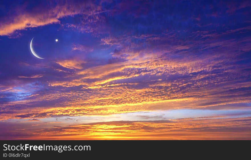 Red sunset and moon . Eid Mubarak background . Against the background of clouds . beautiful sky . Nasa . Yellow and pink clouds . Sunset and new moon . Prayer time .Half moon and star. Red sunset and moon . Eid Mubarak background . Against the background of clouds . beautiful sky . Nasa . Yellow and pink clouds . Sunset and new moon . Prayer time .Half moon and star