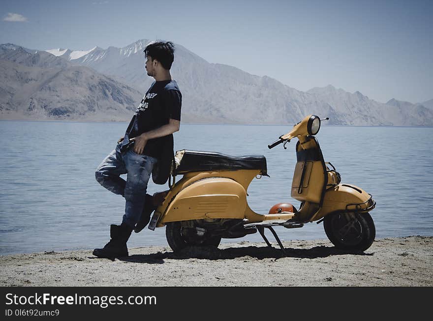 Photo of Man Leaning on Motorcycle