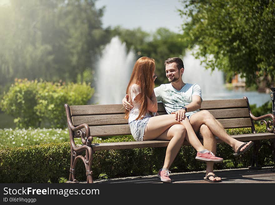 Man and Woman Sitting on a Bench