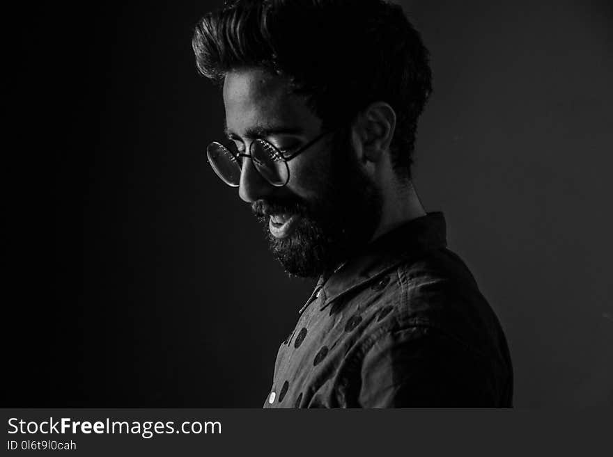 Grayscale Photography of Man Wearing Round Eyeglasses