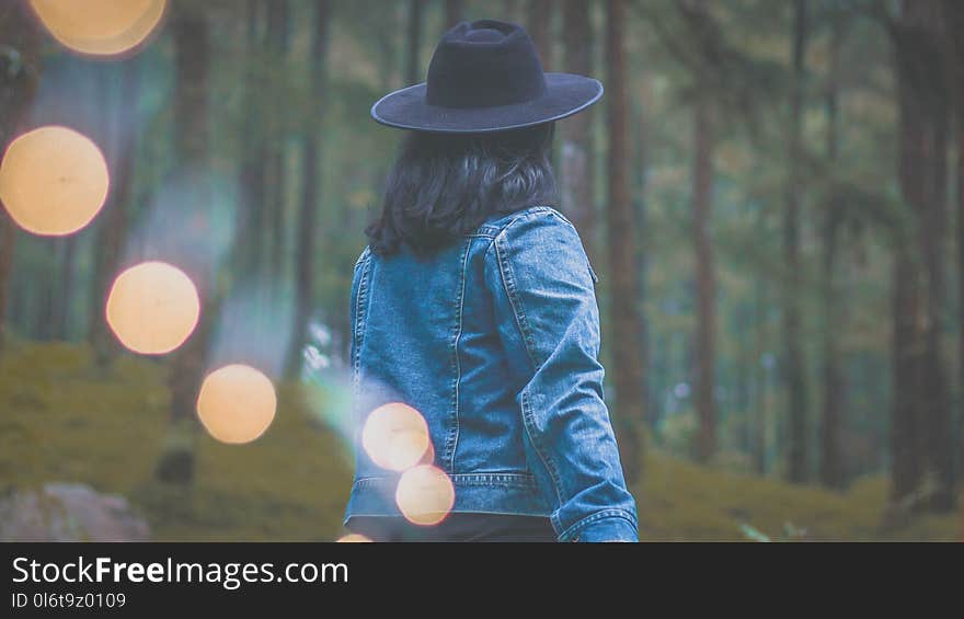 Photo of Woman Wearing Denim Jacket and Black Hat