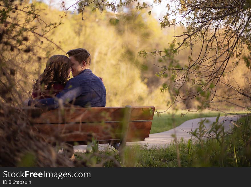 Photography of Couple Sitting on Bench