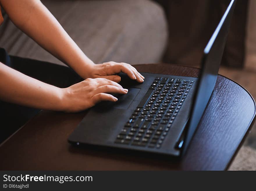 Person Working on Black Laptop.