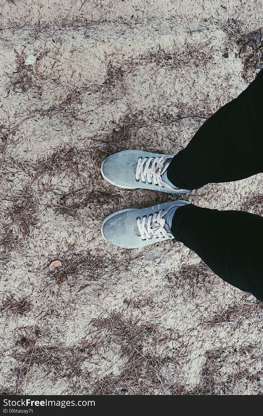 Person in Black Pants and Pair of Blue Sneakers