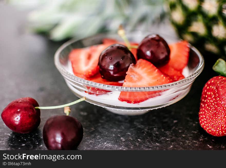 Cherries and Sliced Strawberries on Clear Bowl