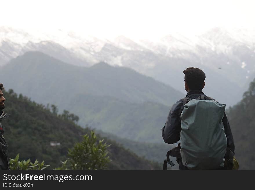 Man With Gray Backpack Across Mountain