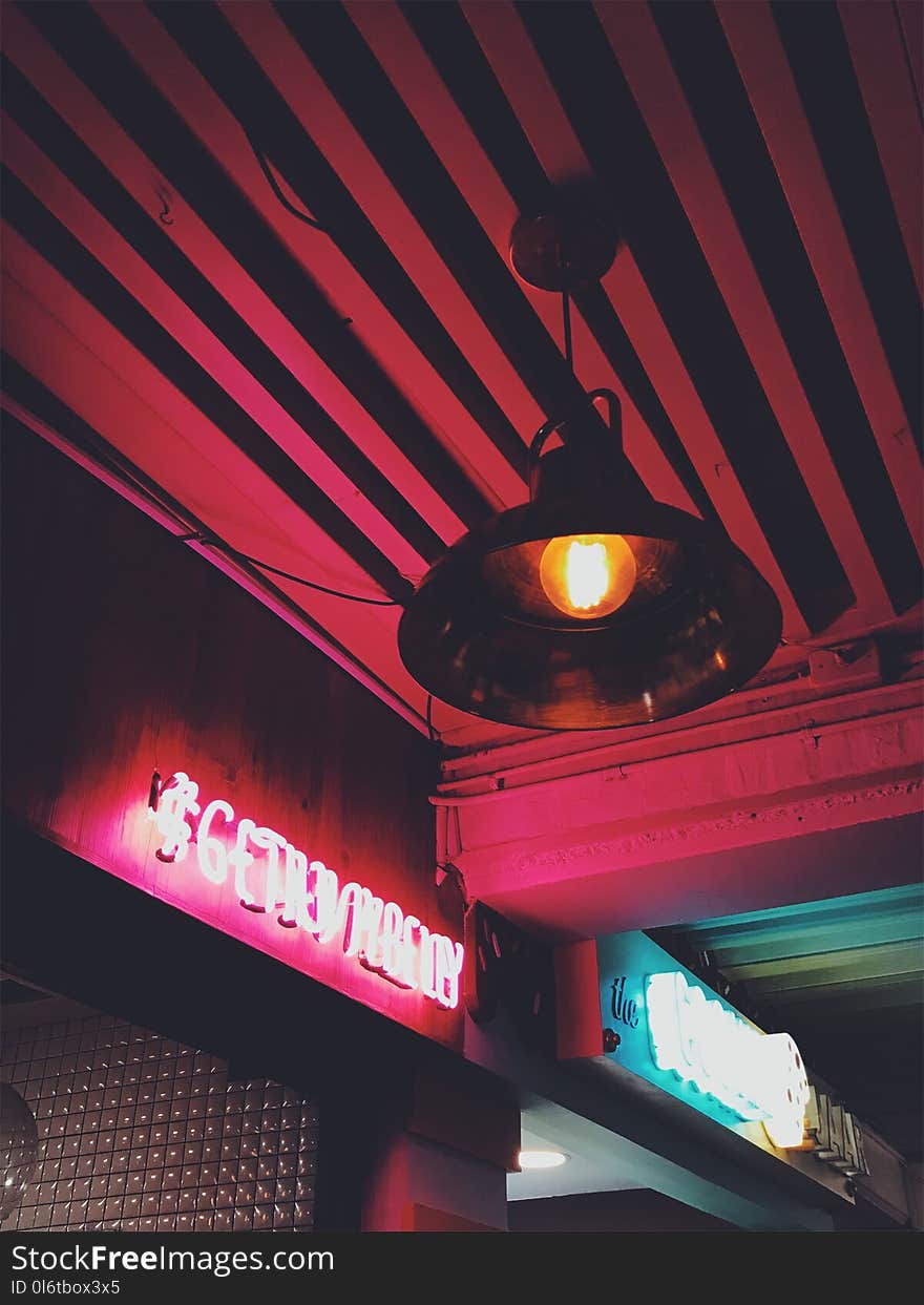 Round Brown Pendant Lamp on Red Ceiling Turned on