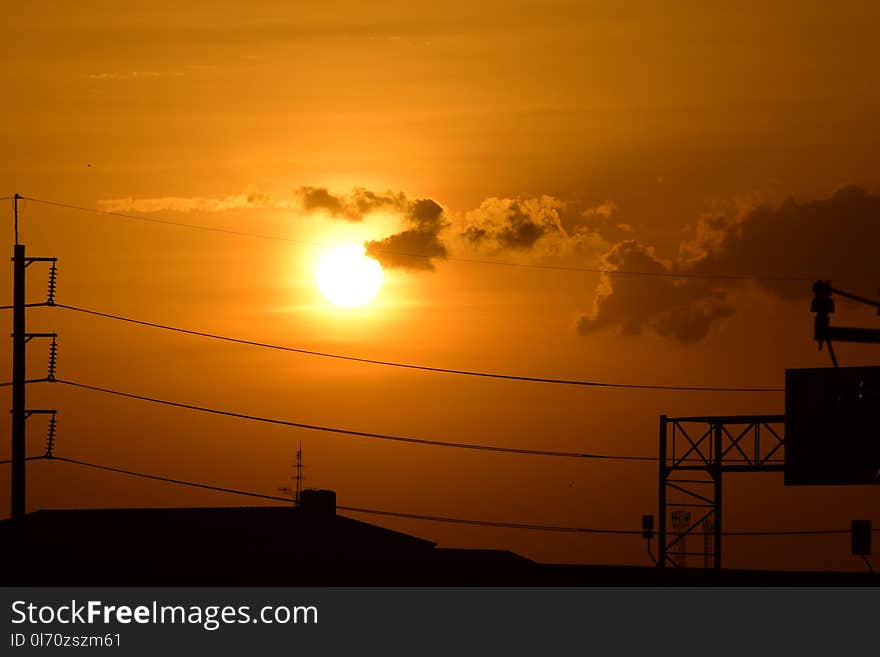 Golden sunset with Power poles and power lines.