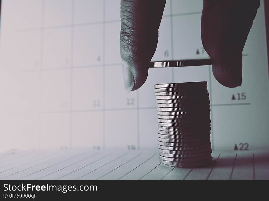 Stack of silver coins on book