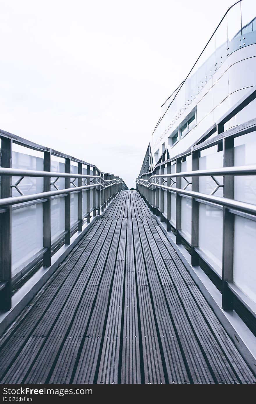 Photo of Brown Wooden Path Near White Building