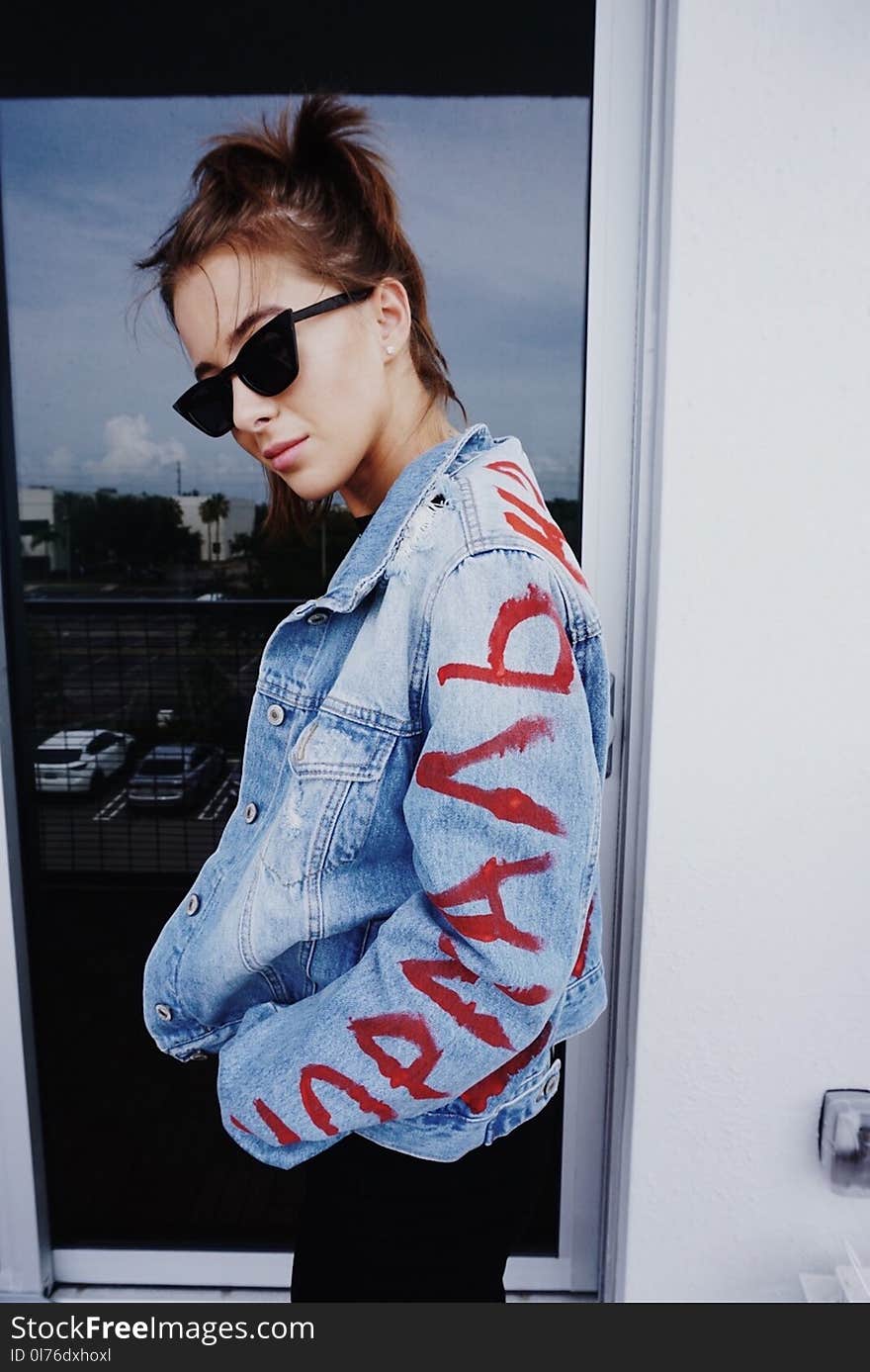 Woman in Painted Denim Jacket Wearing Black Sunglasses