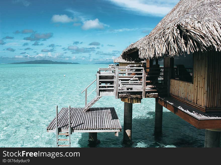 Brown Nipa Hut on Body of Water