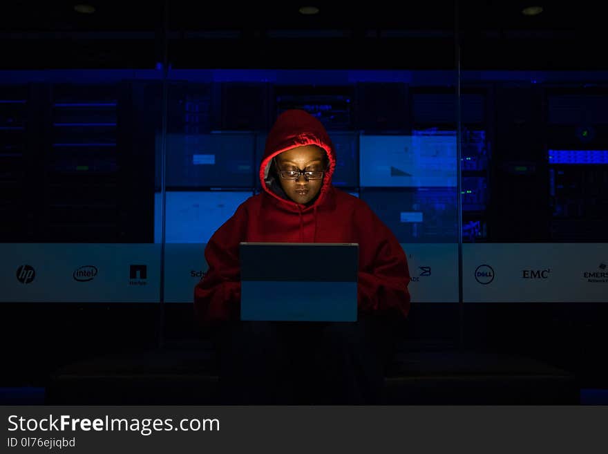 Woman Wearing Hooded Pullover Hoodie Facing Tablet Computer