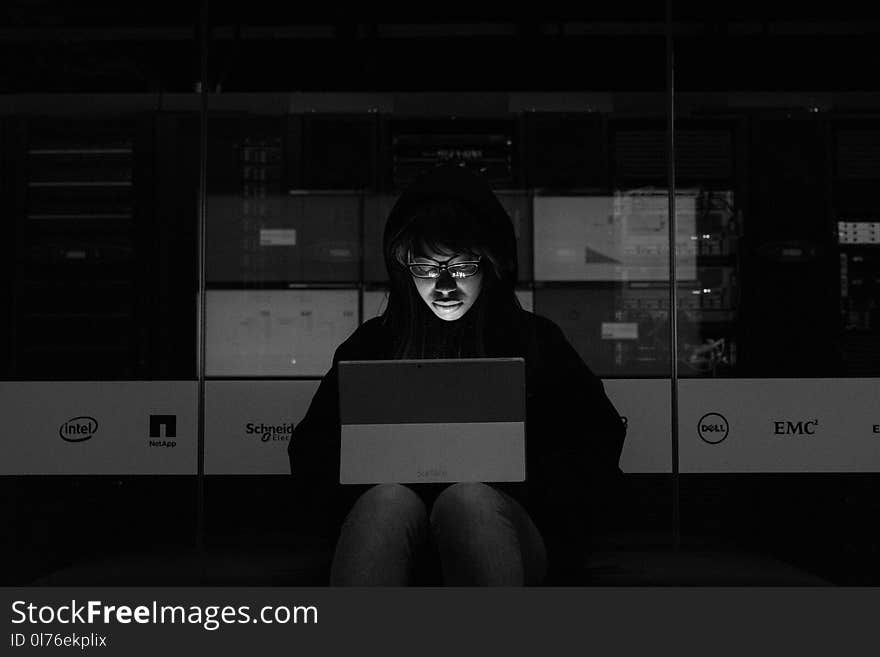 Gray scale Photograph of a Woman using a Laptop