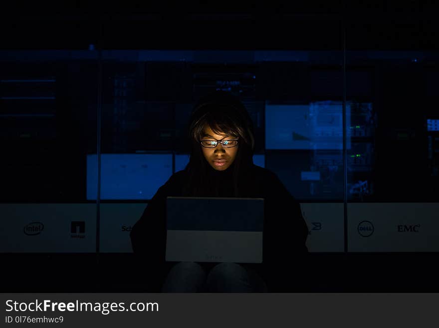 Woman Wearing Black Hoodie Jacket Holding Grey Laptop Computer