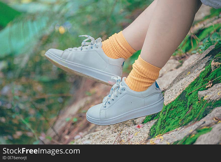 Person Wearing White Plimsoll Shoes