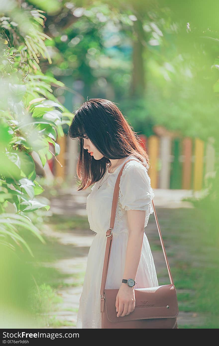 Woman Wearing White Crew-neck Short-sleeved Dress Standing Beside Green Leaf Plant