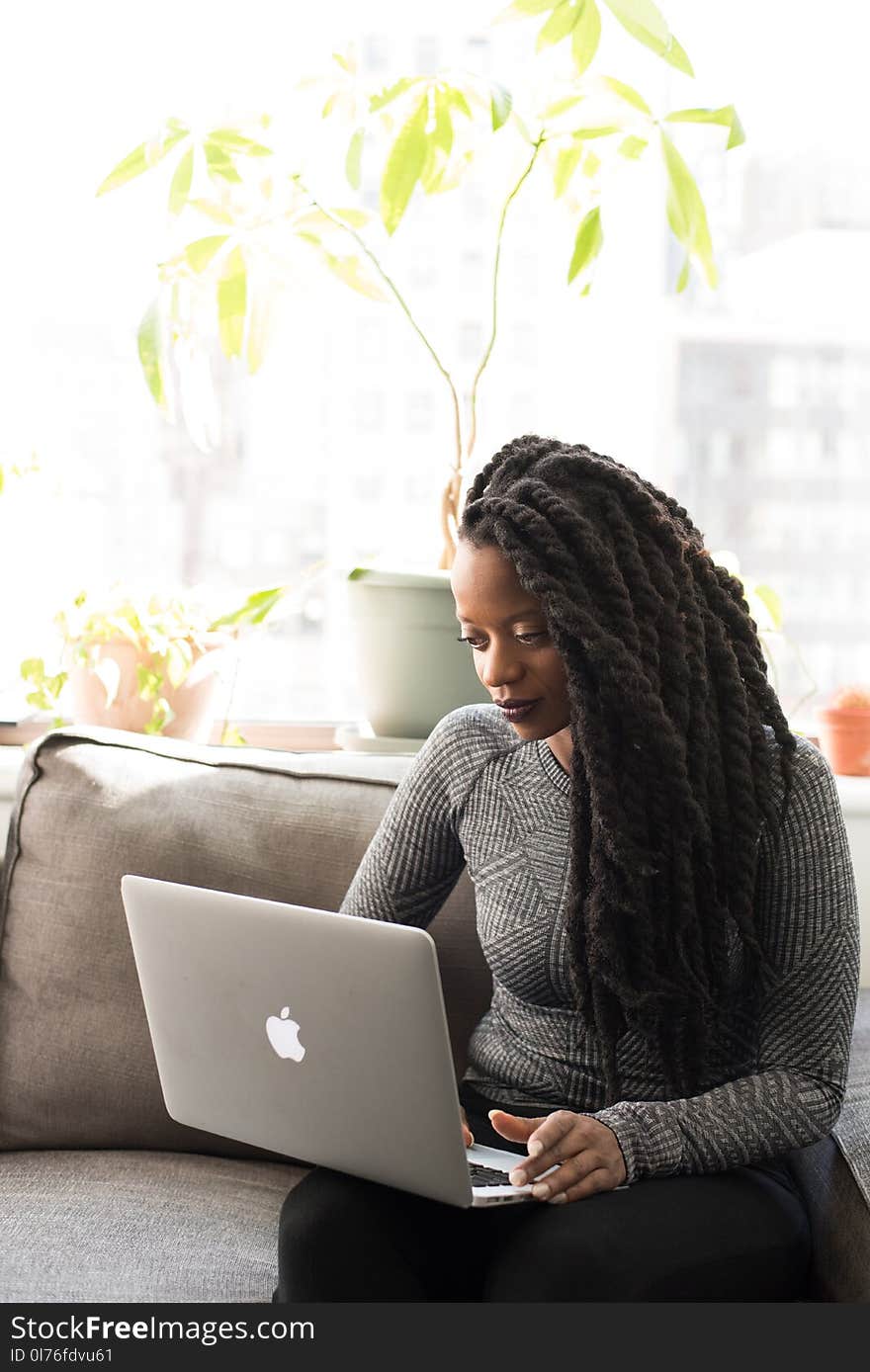 Woman in Gray Sweater Using Macbook Pro