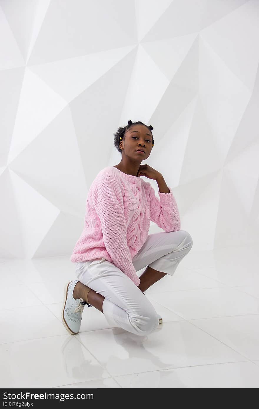 Woman Wearing Pink Sweater and White Pants Posing