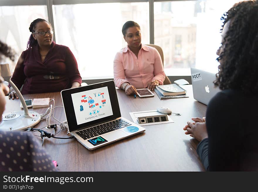 Four Women Sitting on Chair and Taking Talk over