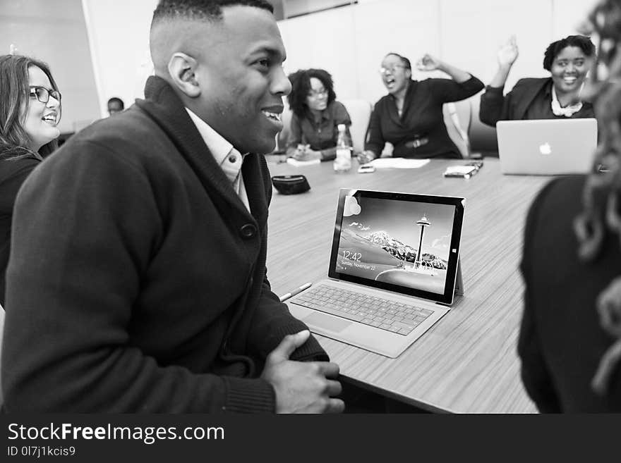 Grayscale Photo of Group of People Laughing