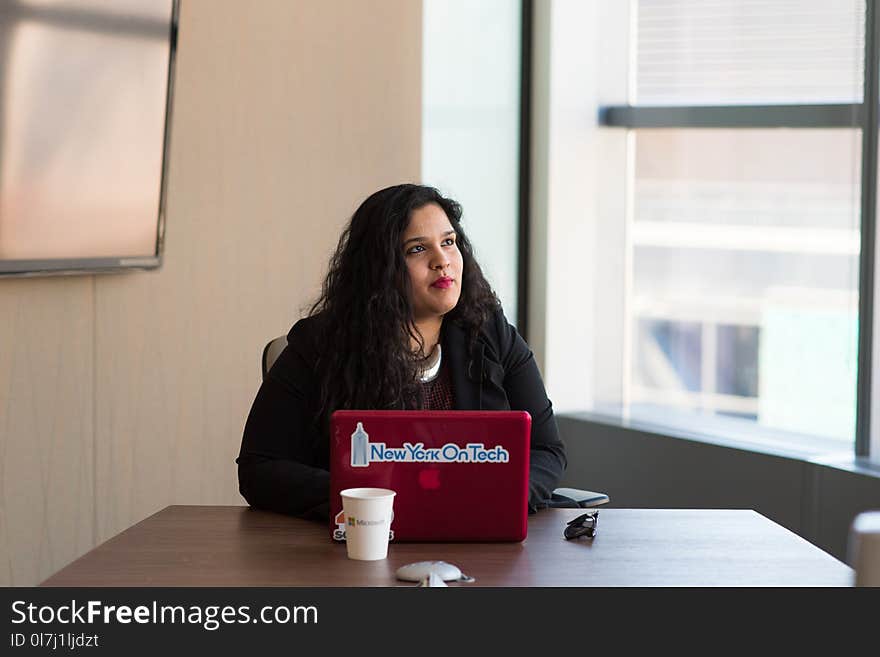 Woman Wearing Black Long-sleeved Shirt Using Red Macbook