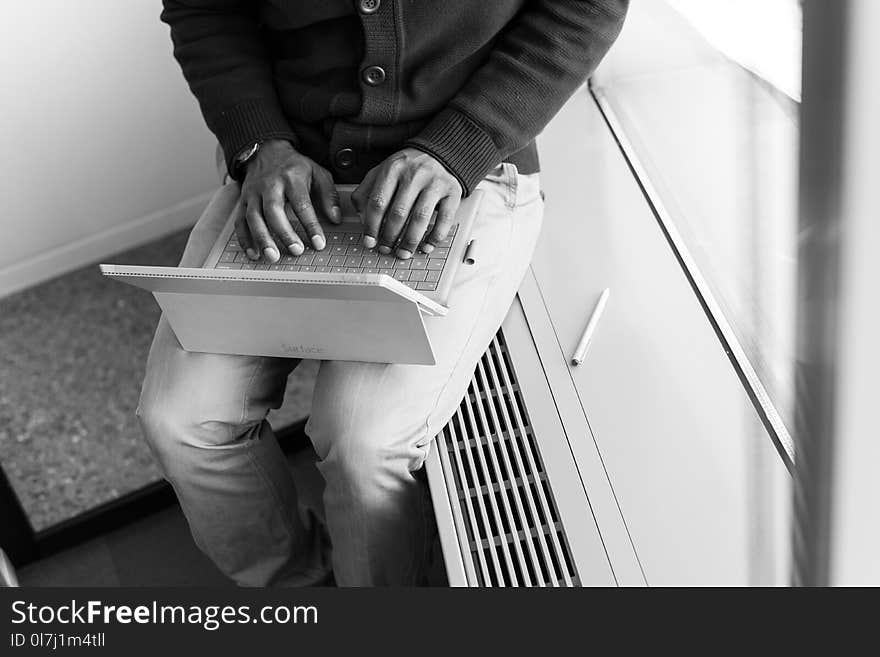 Greyscale Photo of Man Using Laptop Computer