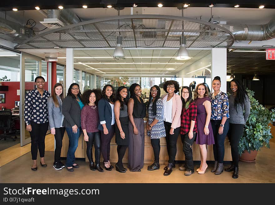 Group of Women Standing Near Desk