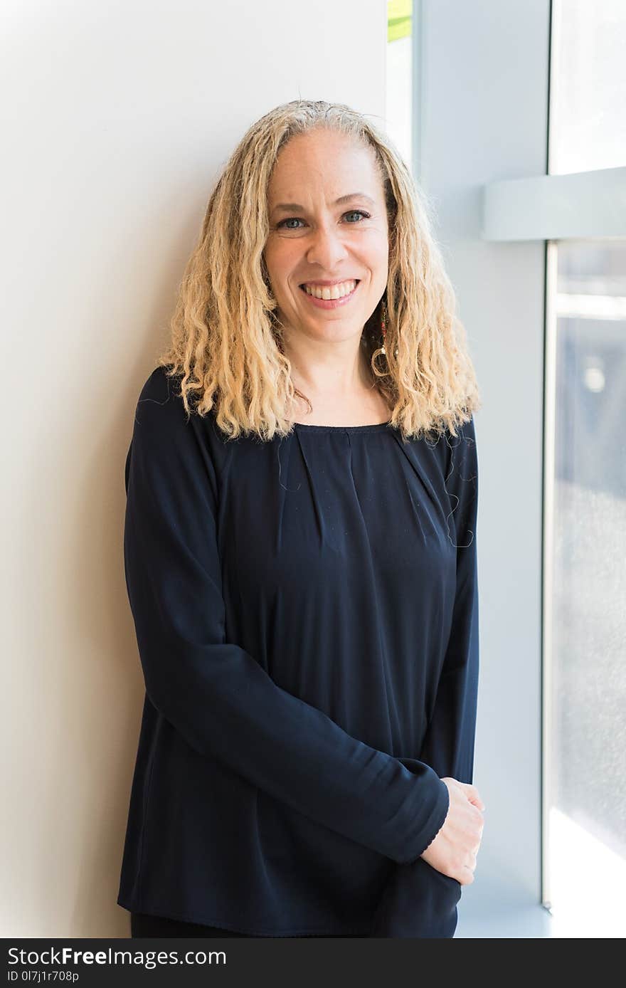 Woman Wearing Black Long-sleeved Shirt Leaning on Wall