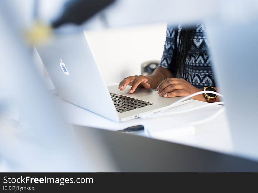 Person in Front of Table Using Macbook