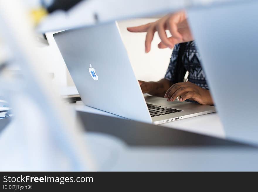 Person&#x27;s Fingers Pointing in Macbook Pro