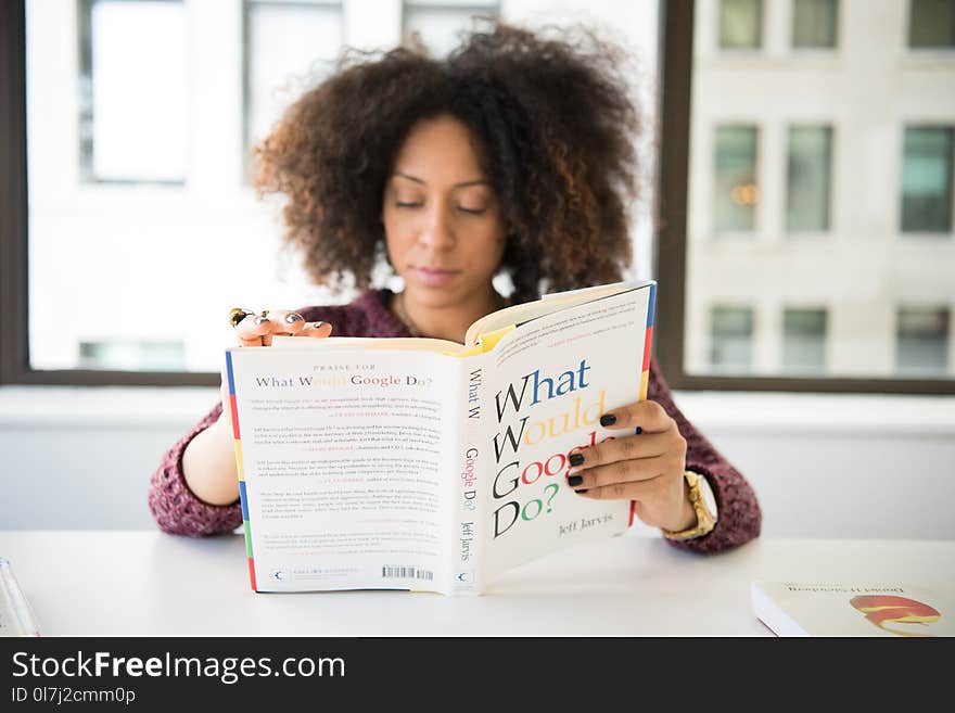 Woman Wearing Maroon Crochet Long-sleeved Shirt Reading What Would Google Do Book