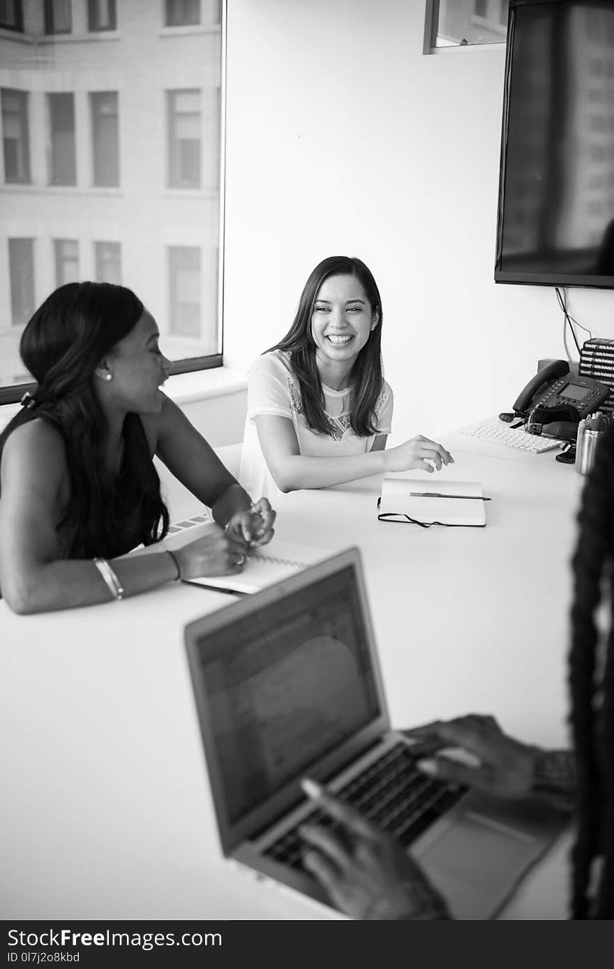 Two Women Behind Table