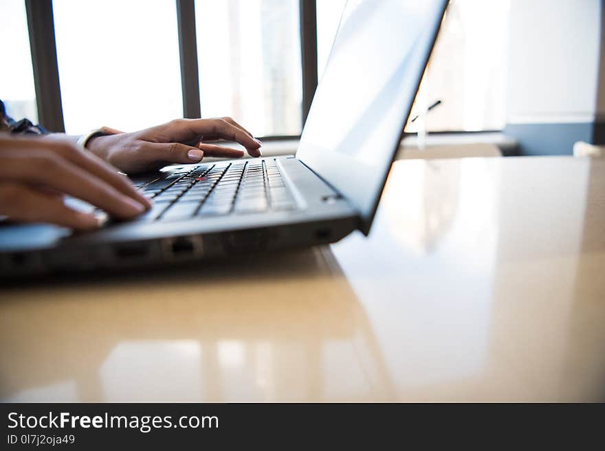 Black Laptop Computer on Brown Wooden Table