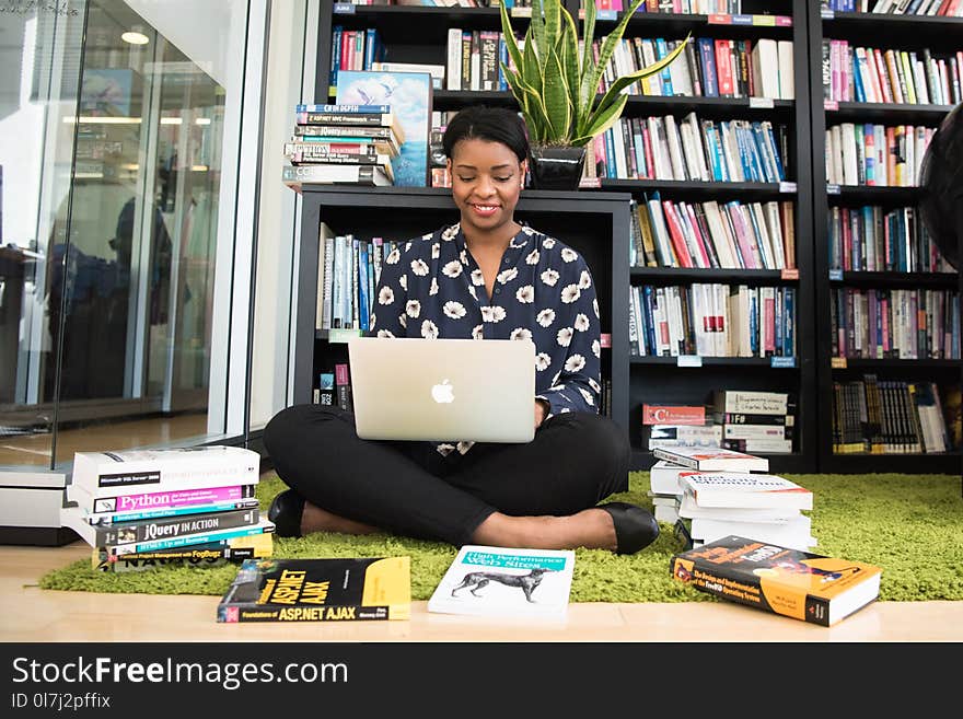 Woman in Black Shirt Using Macbook