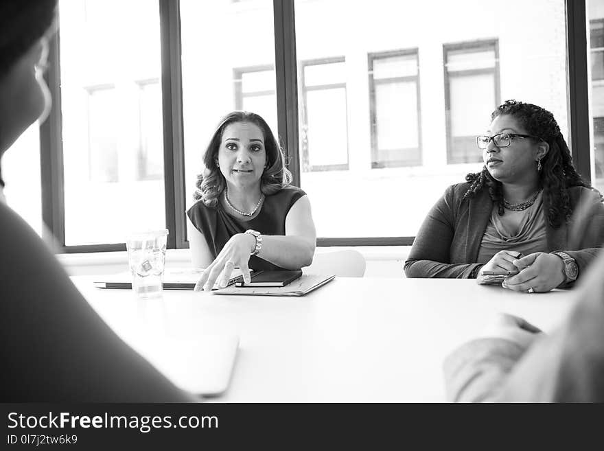 Photo of Four People Having Conversation in Room