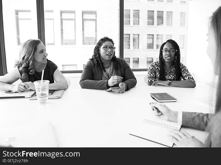 Four Women Sitting Near Table