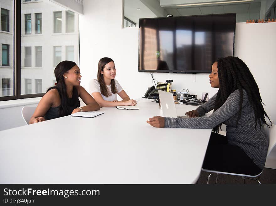 Group of Women Sitting on Chairs