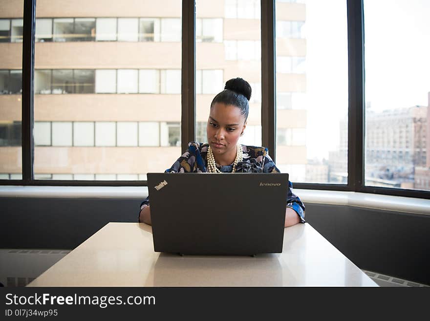 Woman Sitting on Sofa Facing Lenovo Thinkpad