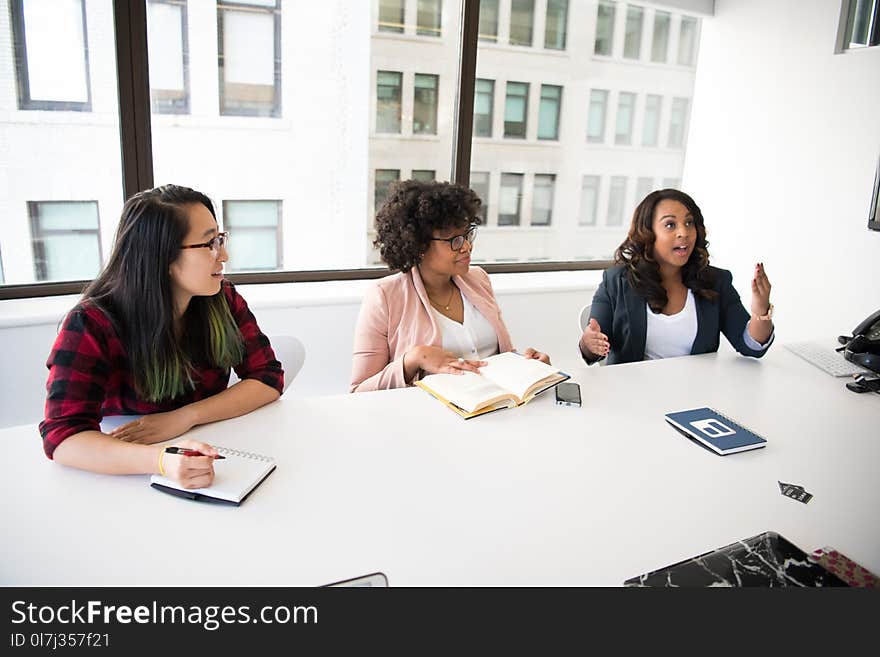 Three Women in Front of Desk