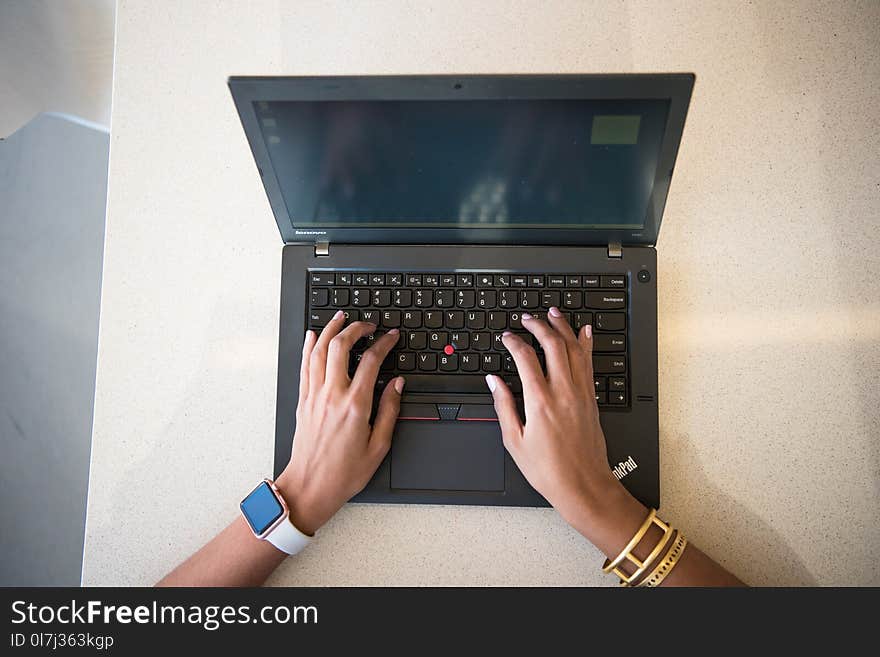 Human Hand on Black Lenovo Thinkpad