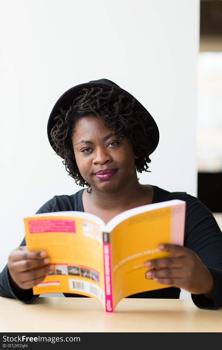 Woman With Black Hat Holding Book