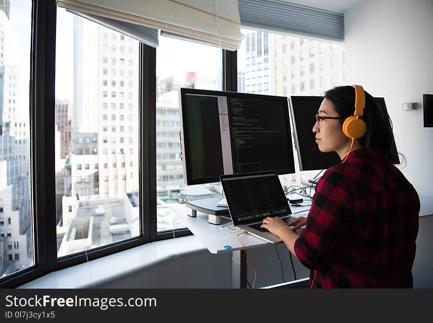 Woman Sitting While Operating Macbook Pro