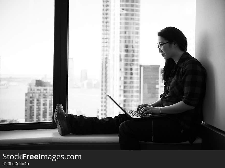 Grayscale Photo of Woman Wearing Eyeglasses