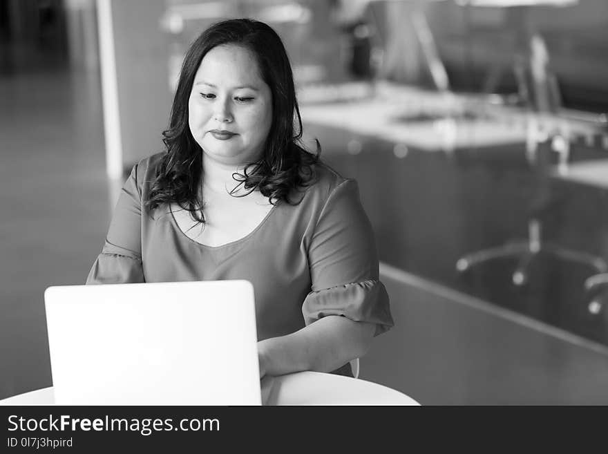 Woman in Front of Table Looking at Laptop