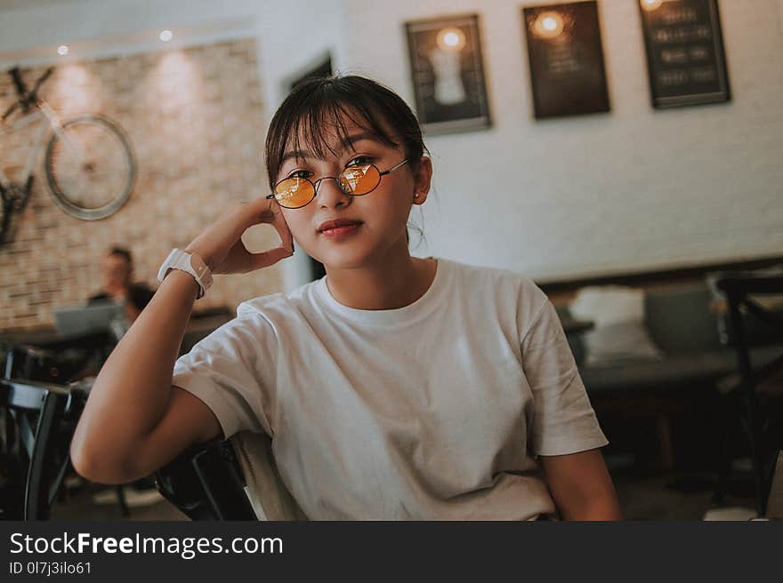 Woman Sitting Wearing Sunglasses