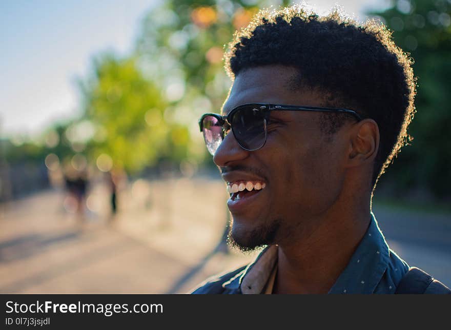 Man Wearing Blue Shirt Smiling Outside