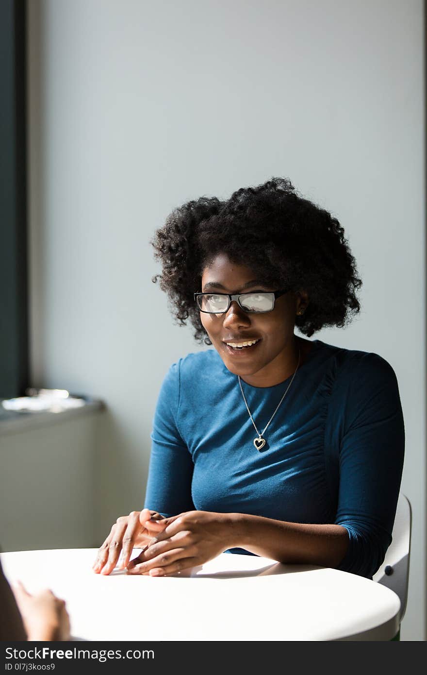 Woman Wearing Black Framed Eyeglasses and Blue Crew-neck Elbow-sleeved Top