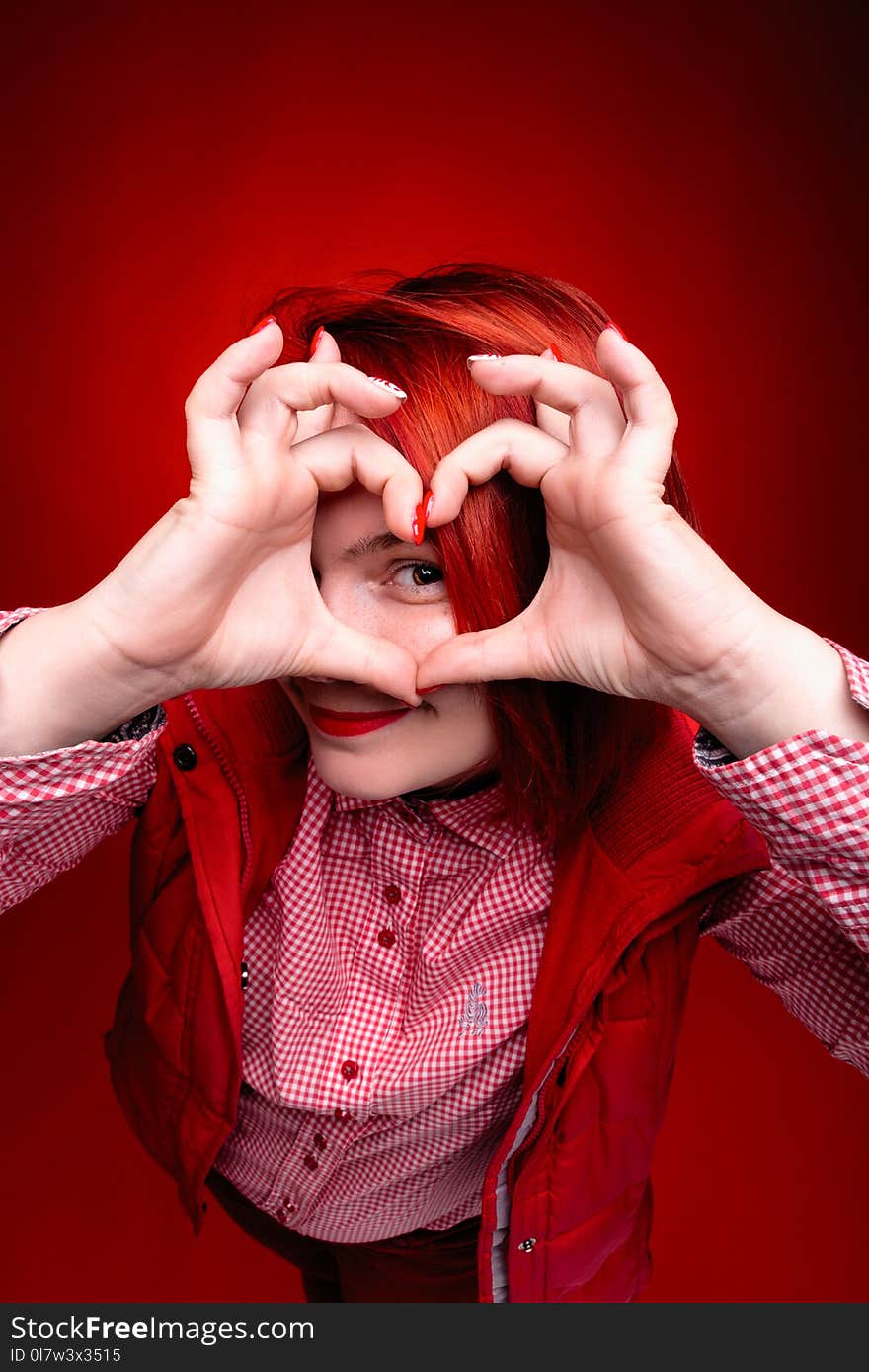 Red hair girl in studio with red color clothes, close portrait w